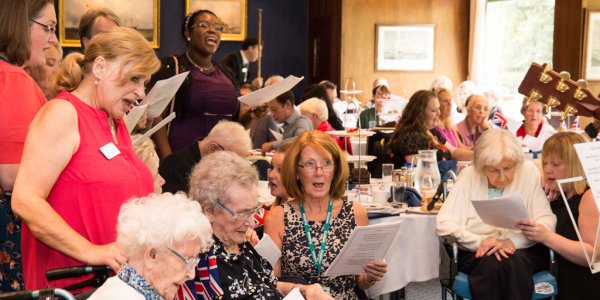 Group photo of residents and the Chesham Leys care team singing