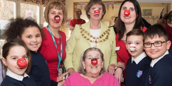 Cllr Mayor Barbara Russel with care team, resident and school children for Red Nose Day