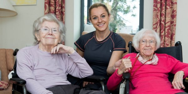 Two female residents with volunteer at Meadowside care home