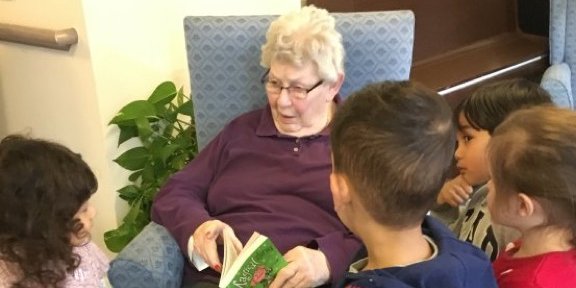 Helen Paiba with children reading book