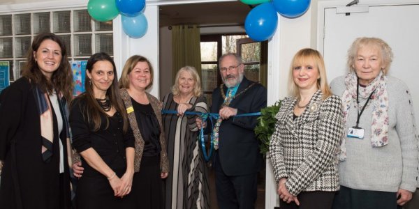 Mayor cutting ribbon on new community space
