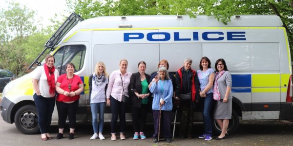 Group stood by Police van smiling at camera