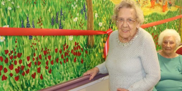 Residents standing by wall mural