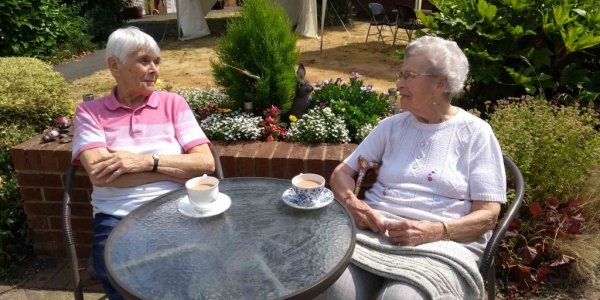 Phyllis and Jean chatting over a cup of tea