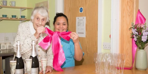 Resident cutting ribbon of new cafe at Icknield Court