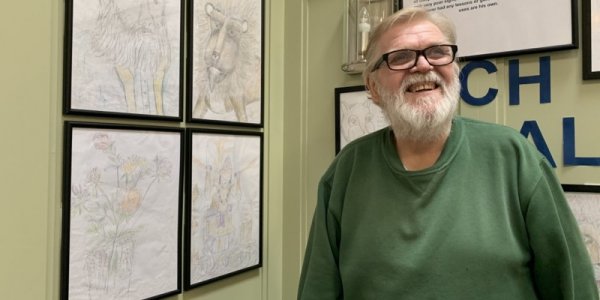 Michael Perfect with his gallery of sketches at Farnham Common House
