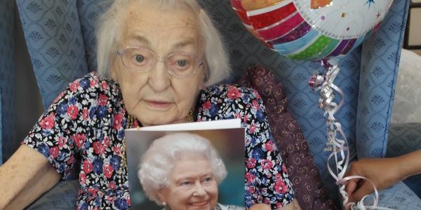 Doris holding birthday card from HM Queen