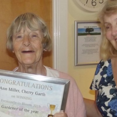 Resident holding certificate, with carer