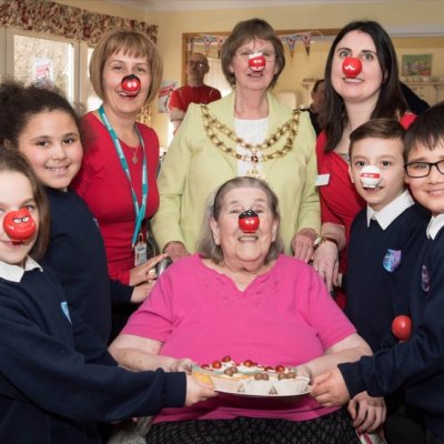 Cllr Mayor Barbara Russel with care team, resident and school children for Red Nose Day