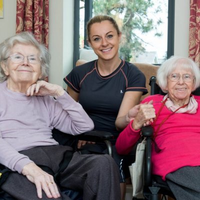 Two female residents with volunteer at Meadowside care home