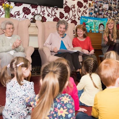 Care home residents and tots share treasured reads during National Storytelling Week