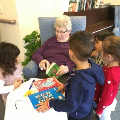 Helen Paiba with children reading book