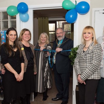 Mayor cutting ribbon on new community space