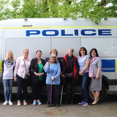Group stood by Police van smiling at camera