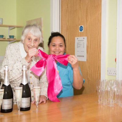Resident cutting ribbon of new cafe at Icknield Court
