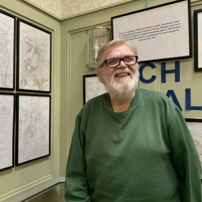 Michael Perfect with his gallery of sketches at Farnham Common House