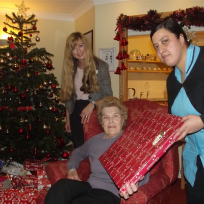 Carer giving resident a Christmas present