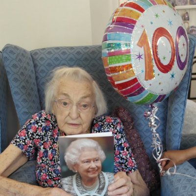 Doris holding birthday card from HM Queen